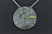 Albatross at sea with 22ct gold sunrise silver pendant