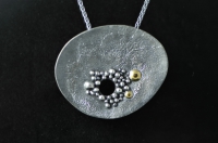Reticulated, granulated, black and gold, asymmetrical silver pendant