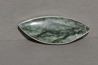 Pounamu and silver brooch