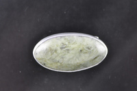  Pounamu and silver brooch.