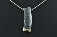 Textured, 18ct gold and blackened silver pendant