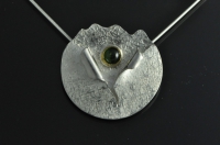Textured hollowform silver pendant with gold mounted cats-eye green Kornupine