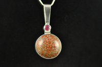 Agatised Dinosaur bone, Ruby and silver pendant